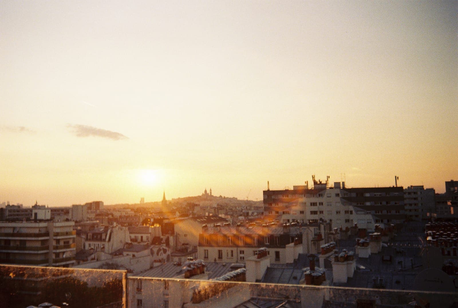 sunset flaring over city rooftops
