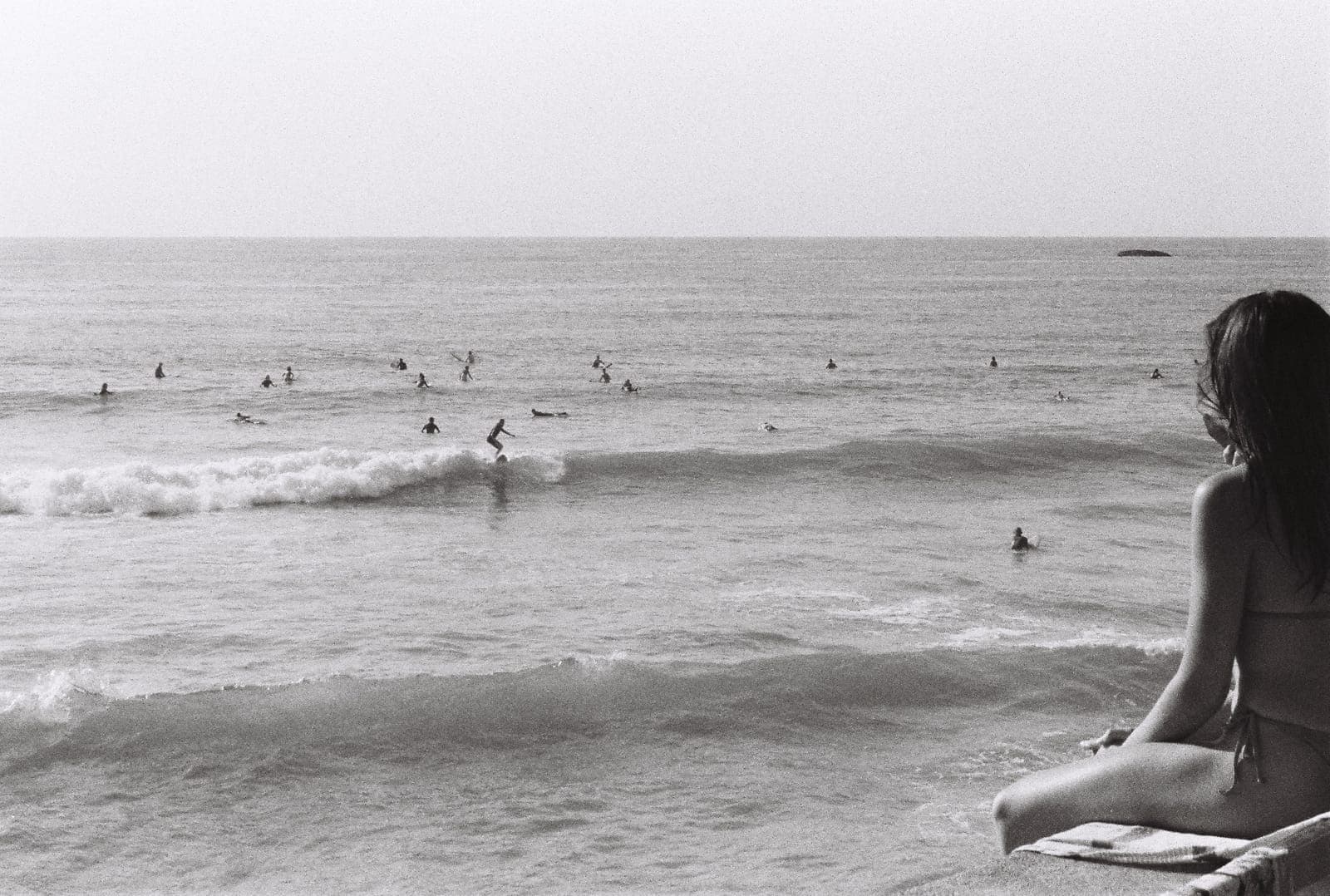 surfers waiting in the lineup, in black and white