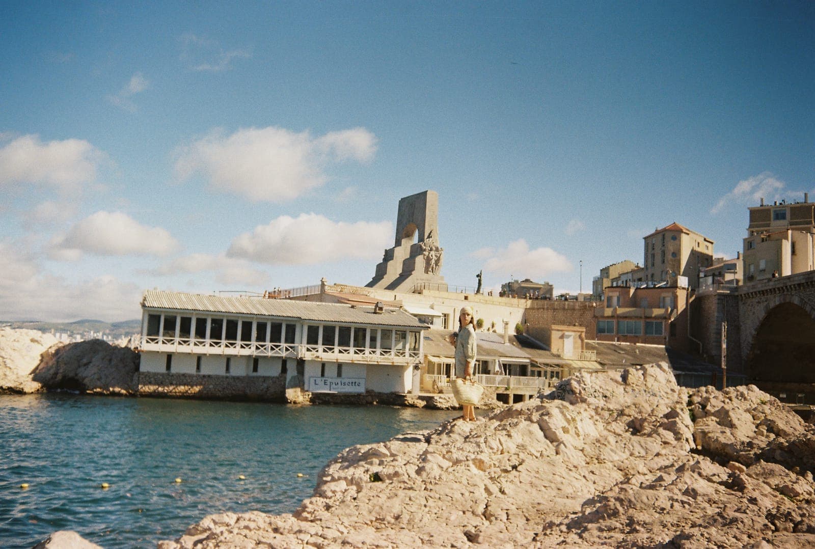 seaside buildings and a monument on the rocks
