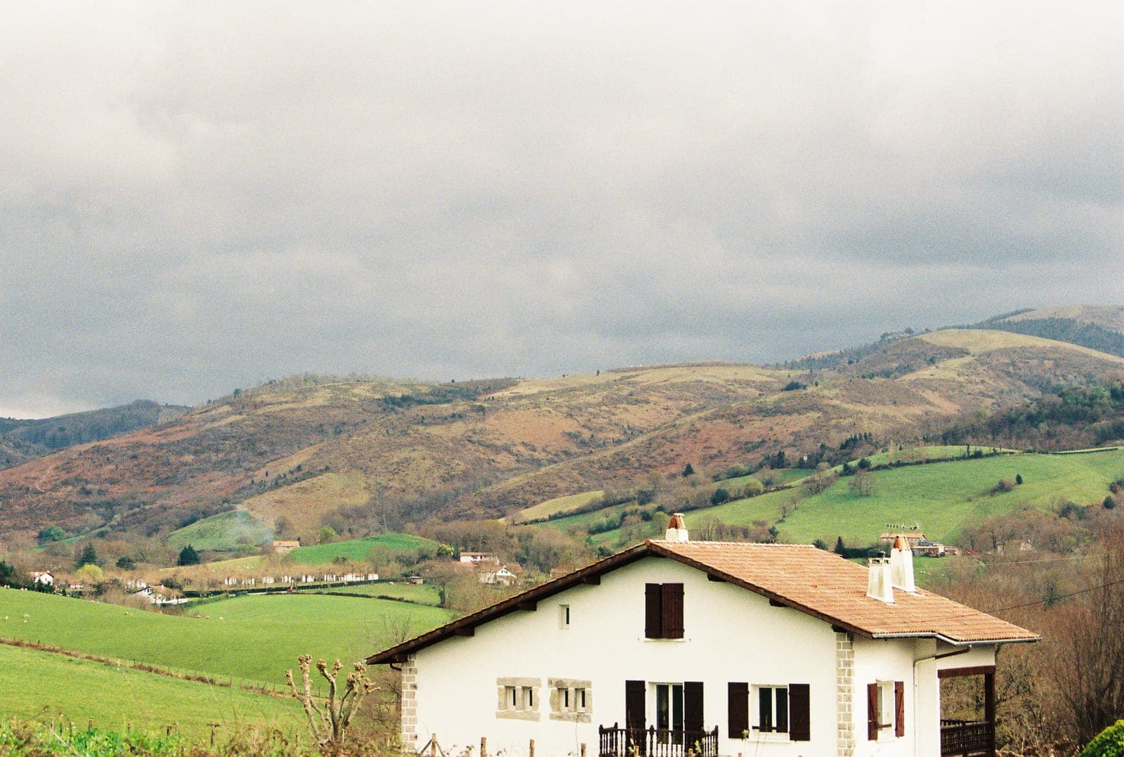 basque house with red shutters on a hillside