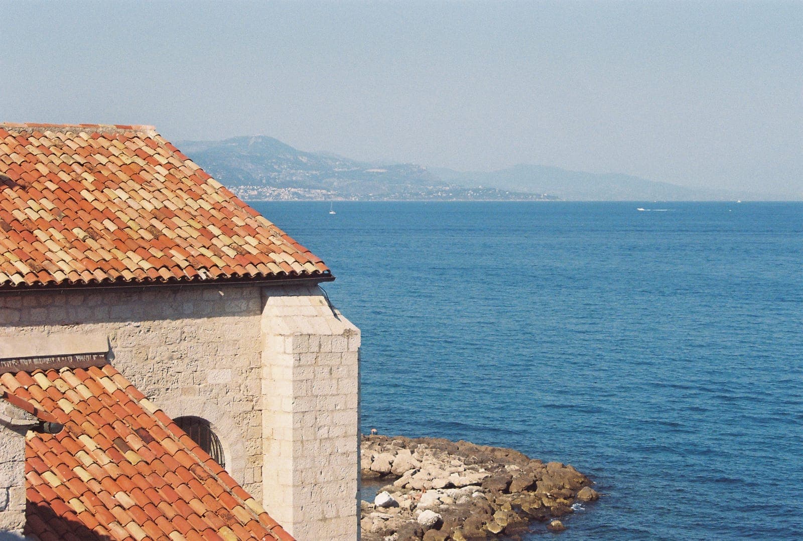 terracotta rooftop against a deep blue sea